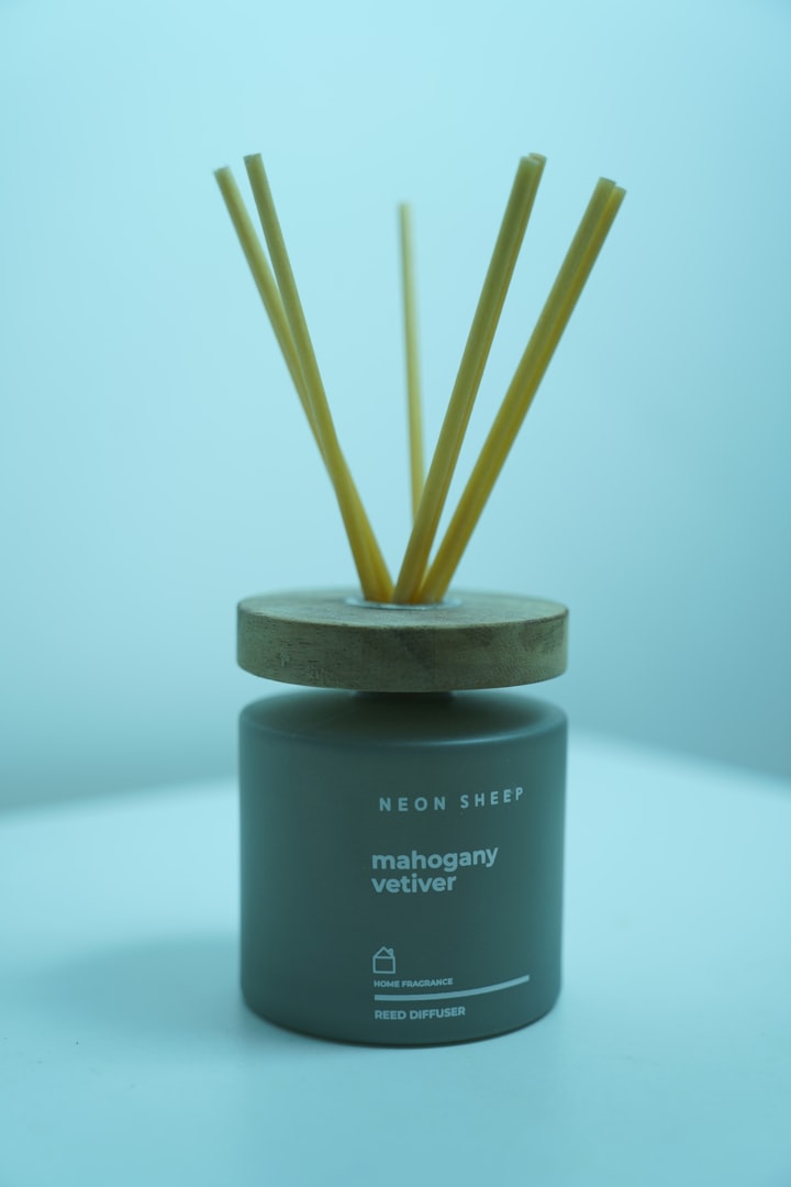 a candle with sticks in it sitting on a table